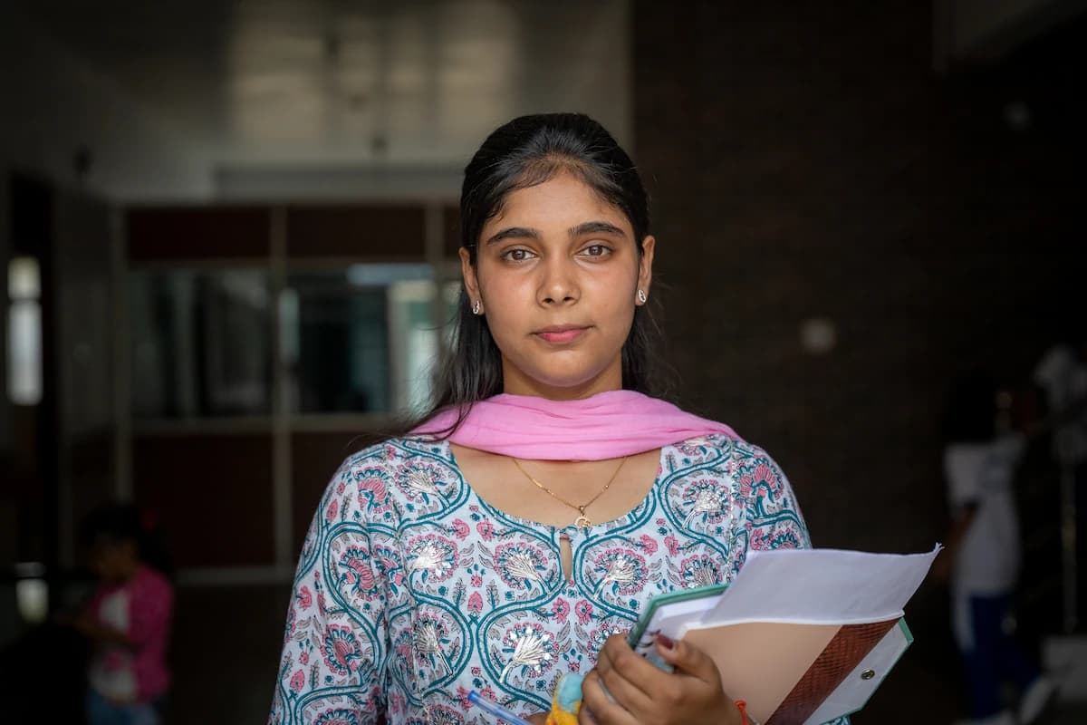 Senior student holding her notebooks in the school corridor
