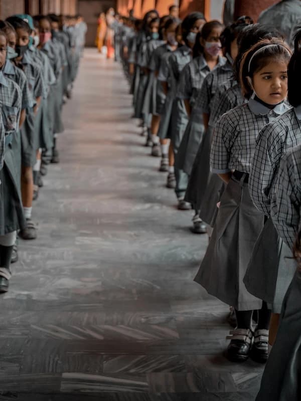 Students lined up in formation along the school corridor