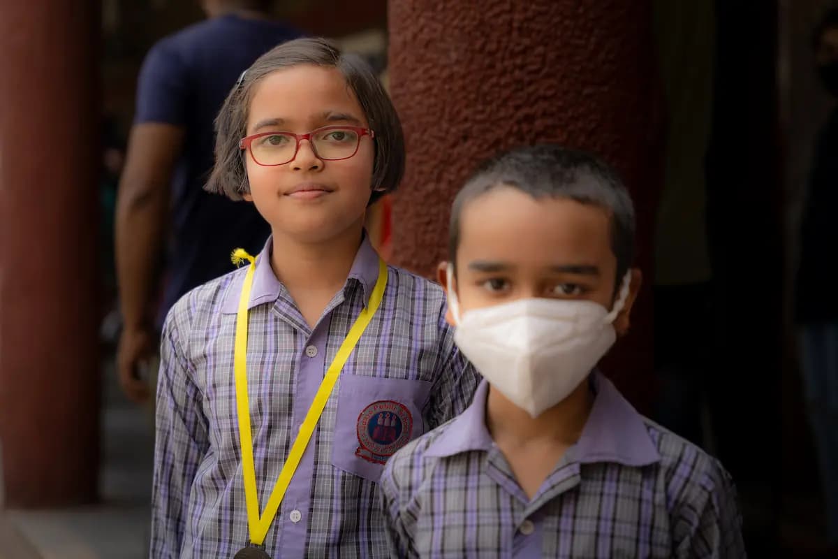 A girl and a boy standing together outside their classroom