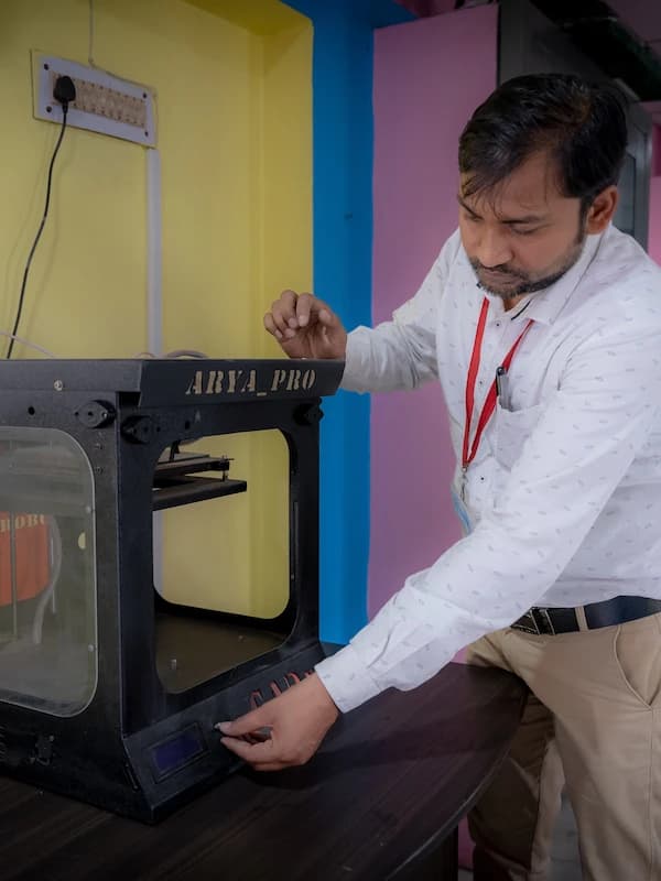 A teacher operating the 3D printer in the Atal Tinkering Lab