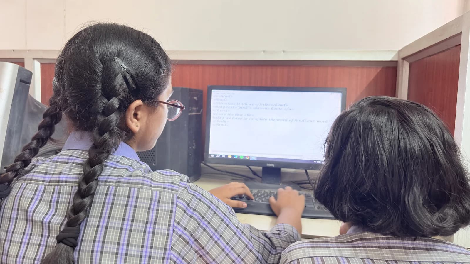 Two students working at a computer in the lab at Udaya Public School, Ayodhya